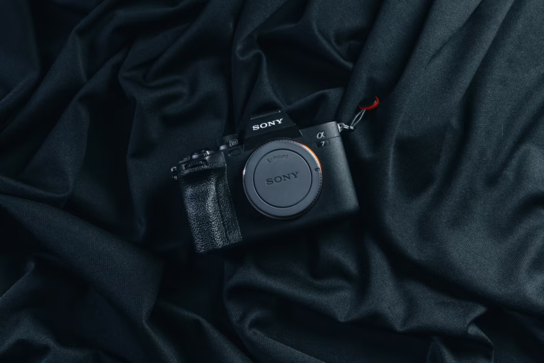 Sony camera placed on elegant dark fabric, showcasing its sleek design.